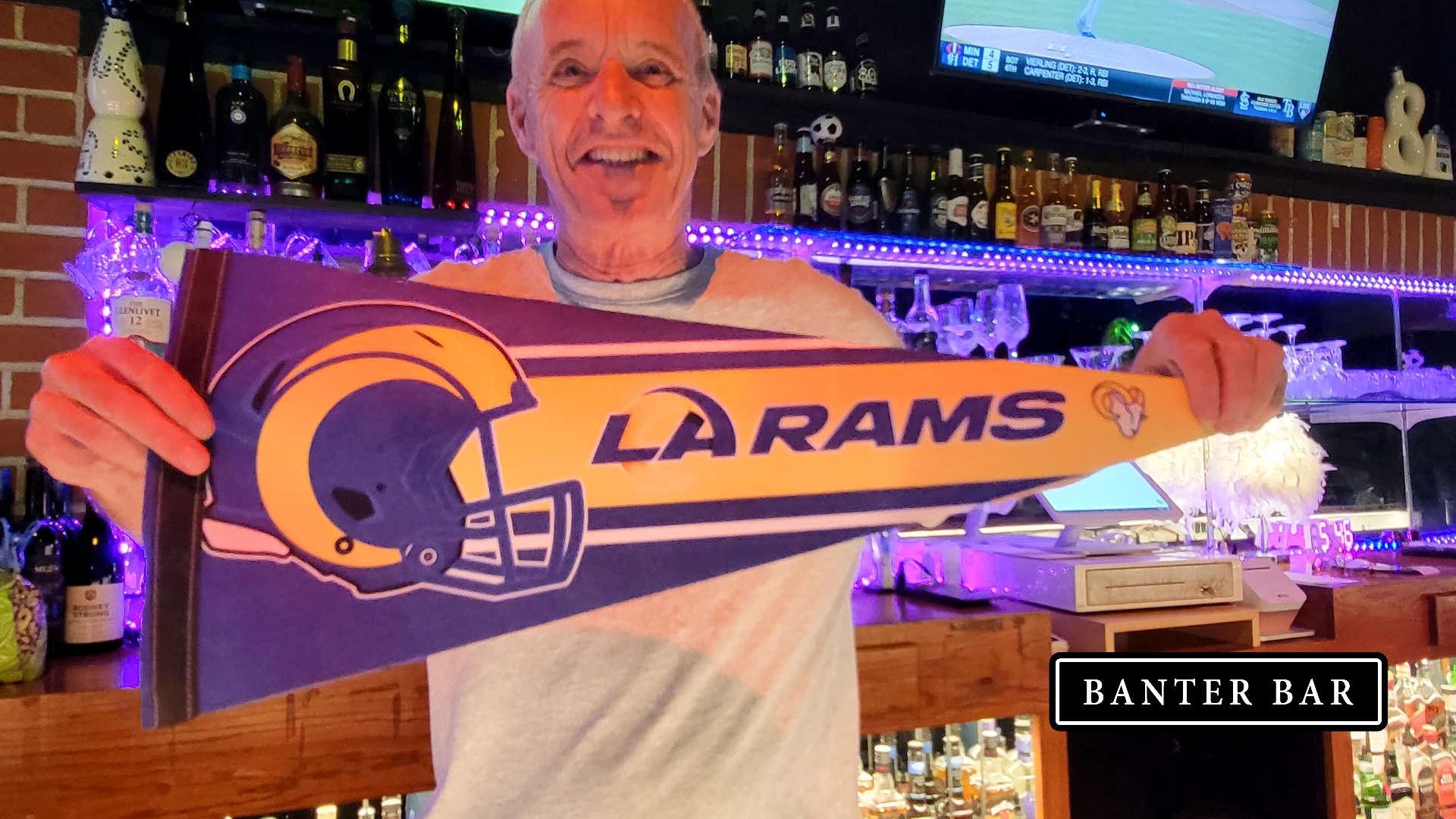 Bartender holds a Los Angeles Rams flag at Banter Bar West Los Angeles