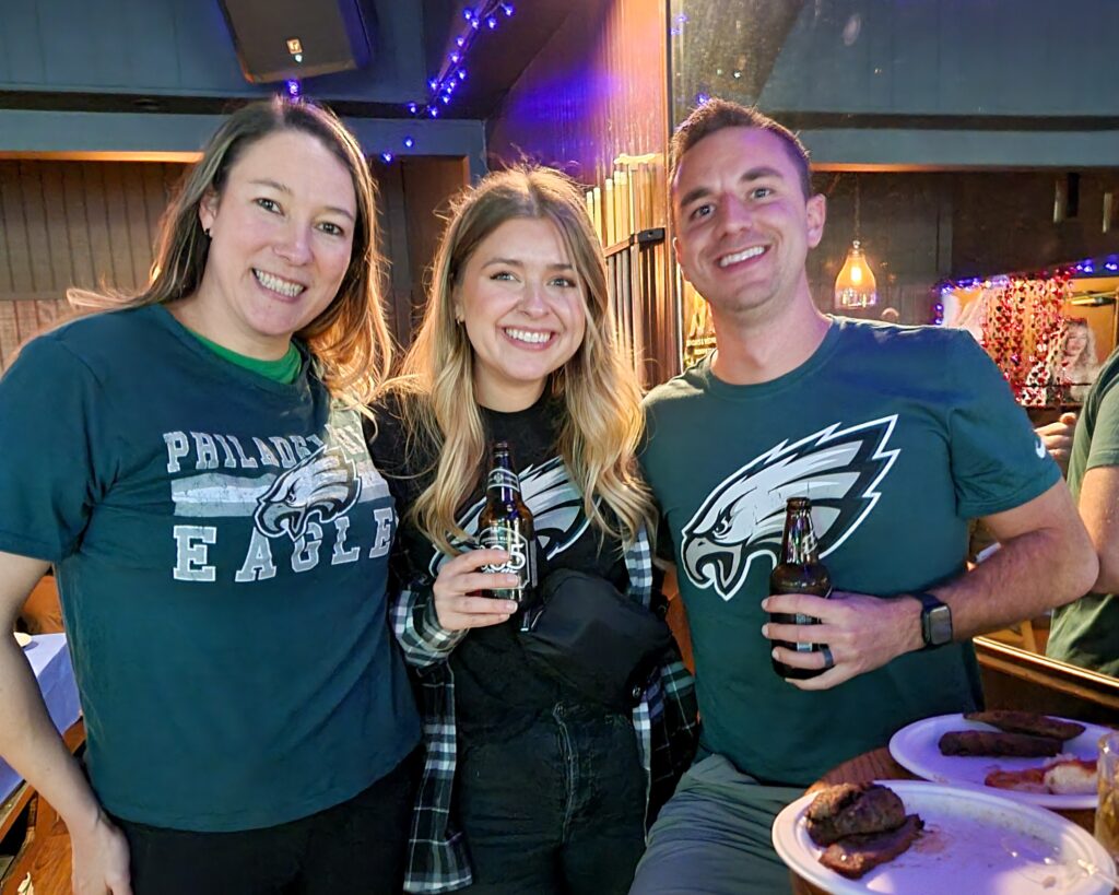 Three Philadelphia Eagles fans post for the camera inside Banter Bar Los Angeles.